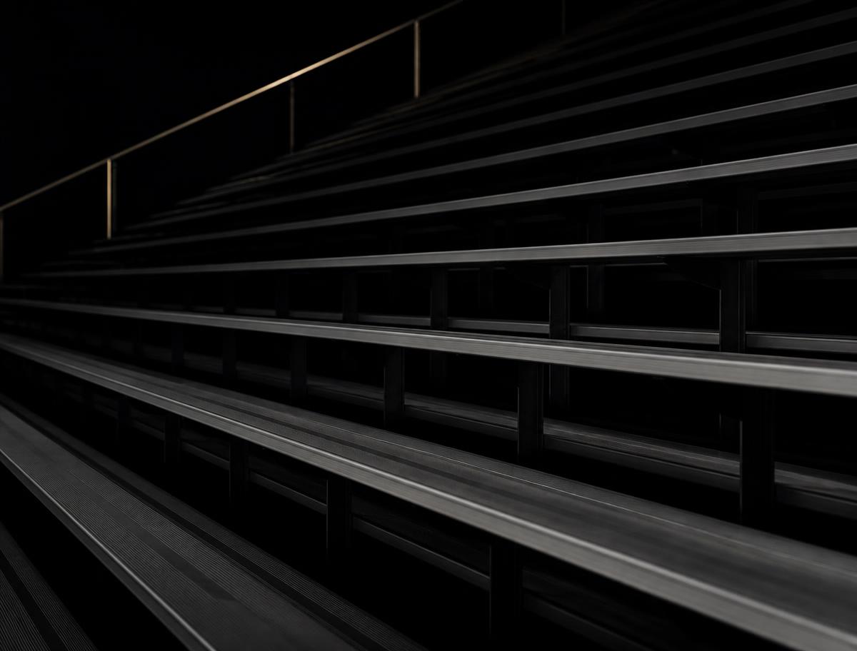 Empty arena bleachers in low light